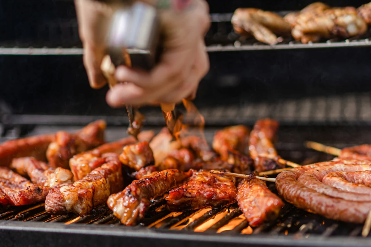 Meat being seasoned on a hot grill
