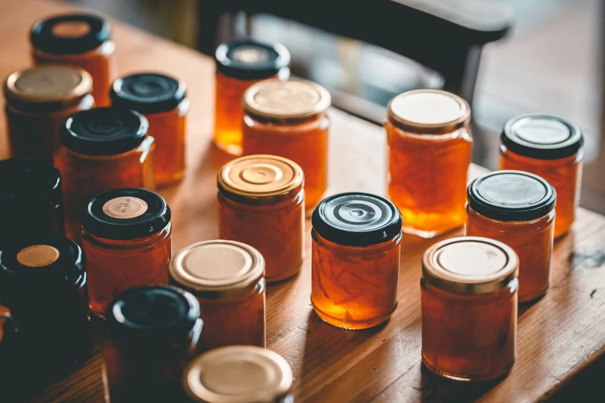Rows of glass jars filled with homemade preserves